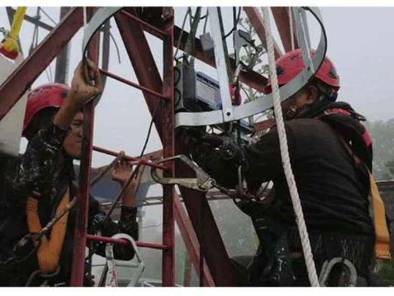 Technicians working at height on a telecom tower